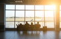 KATOWICE AIRPORT, POLAND - OCTOBER, 2018: Tourists sitting in the airport with suitcases. People are waiting for the flight.