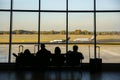 KATOWICE AIRPORT, POLAND - OCTOBER 15, 2018: Tourists sitting in the airport with suitcases. People are waiting for the flight.