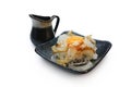 Katsuobushi on sliced onions served with raw egg on top, sprinkled with sesame seeds