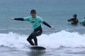 Surf school, a group of people are learning to surf in Chiba close to Ichinomiya.