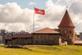 Kaunas castle with historical Lithuanian red flag at cloudy day.