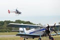 Guimbal Cabri G2 two-seat light helicopter above Antonov An-2 transport aircraft Royalty Free Stock Photo