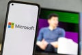 Microsoft logo and Sam Altman in background on screen.Microsoft hires Sam Altman