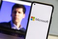 Microsoft logo and Sam Altman in background on screen.Microsoft hires Sam Altman