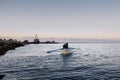 Kavarna, Bulgaria, rowing boat manned by two fishermen comes back from the Black Sea to the bay in the evening