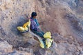 Kawa Ijen Volcano, Banyuwangi, Java Island, Indonesia - 09/09/ 2019: Indonesian sulfur miner is carrying sulfur from the floor of Royalty Free Stock Photo