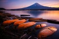 Kawaguchi Lake with mount Fuji wtih orange canoe boat in foreground at sunset, Japan