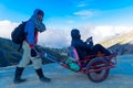 Tourists use a service cart to visited to see view of Ijen crater lake and blue flame early morning
