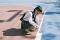 Kawaii girl sitting at basketball court