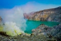 KAWEH IJEN, INDONESIA: Nice overview of sulfur mine with miners working next to volcanic crater lake, spectacular nature