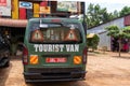 Backside of a tourist safari van, typically seen on East Africa safaris, parked at a restaurant