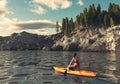 Man canoeing on a lake at mountains Royalty Free Stock Photo