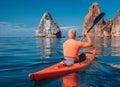 Kayak. Athlete kayaker man enjoys adventure on calm sea with blue water. Leisure activities on the calm blue water. The concept of