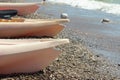 Kayak boat on shore or coast, water on background. Copy space, sport activity. Outdoor recreation