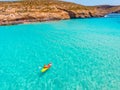 Kayak boat turquoise Blue Lagoon Comino Malta water sea, sunny day. Concept travel. Aerial top view