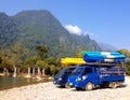 Kayak boats on roof of car beside Nam Song river at Vang Vieng