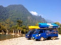 Kayak boats on roof of car beside Nam Song river