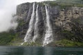 Kayak explorers at Seven Sisters waterfalls sourounded by mystic fog, Geiranger Fjord in Norway Royalty Free Stock Photo