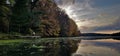 Kayak on mirror Lake sunset at a pier with fall colors reflecting Royalty Free Stock Photo