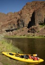 A kayak with nobody on a river in Oregon with mountains Royalty Free Stock Photo