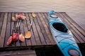 Kayak and oars are dried on the pier