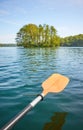 Kayak paddle over the water, ecotourism concept, selective focus