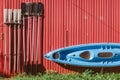 The kayak and paddles are hanging on the wall to dry.