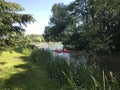 Kayak rowing. Children in lifejackets sail by canoe along the canal in the park.