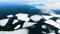 Kayak sailing between ice floes on the lake