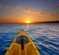 Kayak sailing in ocean sea at sunset