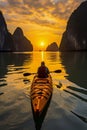 Kayak through serene Ha Long Bay at sunset, admiring the karsts\' reflections and warm-hued sky on still waters Royalty Free Stock Photo