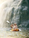 Kayak, summer and friends on river, nature and vacation adventure together in bikini swimsuit. Holiday, waterfall and