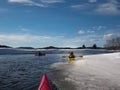 Kayak surfers in action  on an icy lake Royalty Free Stock Photo