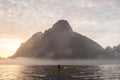 A kayaker appreciates the majesty of Olstinden