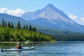 kayaker on a lake with a fishfin mountain backdrop Royalty Free Stock Photo