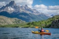 kayaker on a lake with a fishfin mountain backdrop Royalty Free Stock Photo