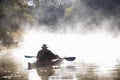 Kayaker in the mist on an autumn morning