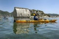 A kayaker paddles past one of the sunken Lycian tombs at the ancient city of Simena in Turkey.
