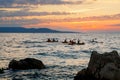 Kayaker paddling the kayak at sunset sea. Kayaking, canoe, paddling. Amazing beach sunset with endless horizon and Royalty Free Stock Photo