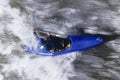 Kayaker Paddling Through Rapids