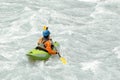 Kayaker paddling in white water rapids, with copy space