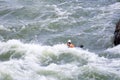 A kayaker paddling whitewater rapids at Great Falls Park, VA