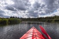 Kayaker point of view. Kayak bow with a view on the river landscape and rushes. River kayaking during summertime concept .