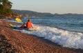 Kayaker Riding Wave onto Beach