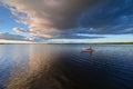 Kayakers on Coot Bay in Everglades National Park under dramatic sunset clouds. Royalty Free Stock Photo