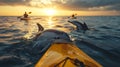 Kayakers encounter dolphins at sunset ocean tour Royalty Free Stock Photo