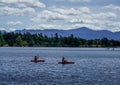Kayakers enjoy summer day on Mirror Lake in Lake Placid, New York State Royalty Free Stock Photo