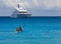 Kayakers on the kayak and a beautiful yacht in the background of clouds on the island of Kefalonia in the Ionian Sea in Greece