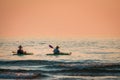 Kayakers on Lake Michigan at sunset in South Haven Michigan