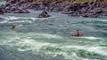 Kayakers navigating through the White Water Rapids and around Rocks Royalty Free Stock Photo